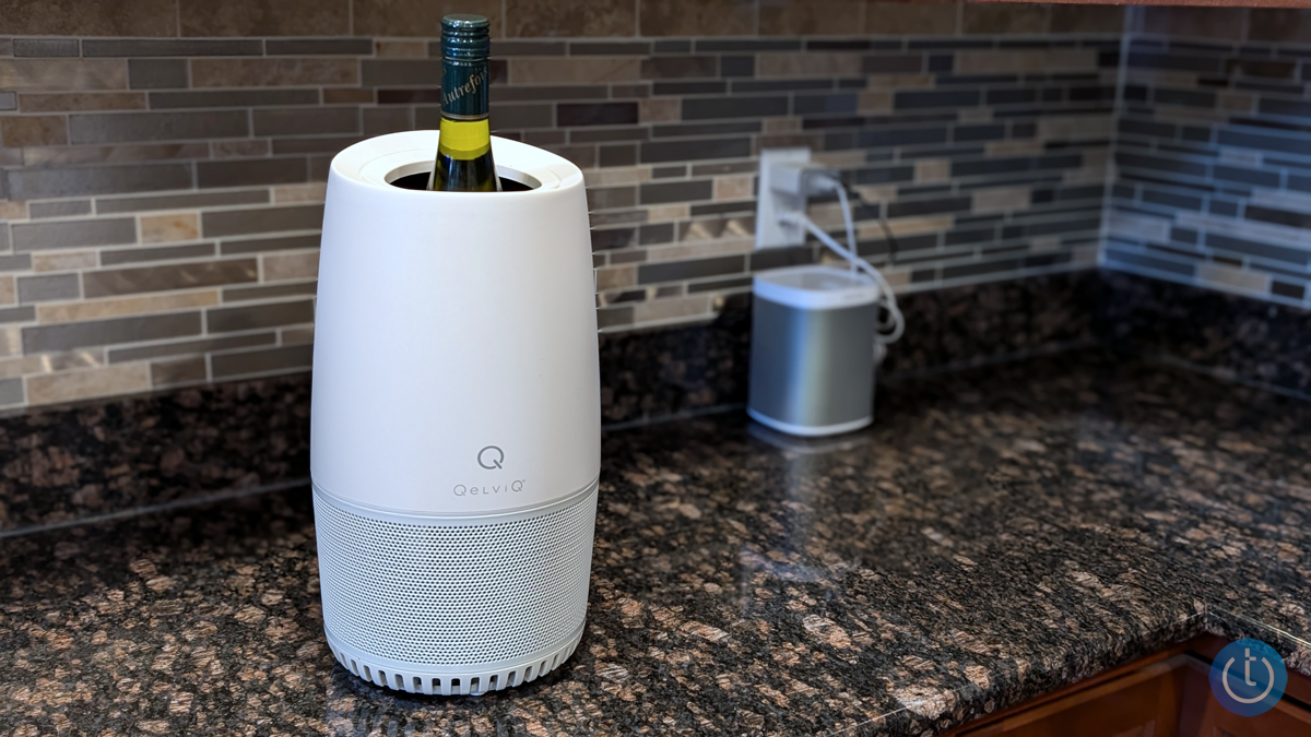 The QelviQ Personal Sommelier sits on a counter with a bottle of wine in it.
